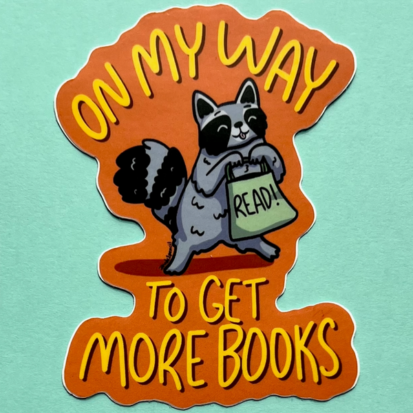 RACCOON ON MY WAY TO GET MORE BOOKS STICKER