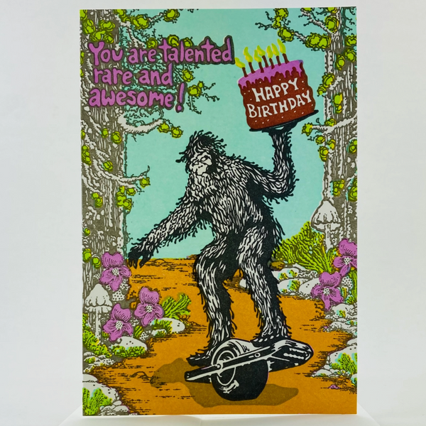 Sasquatch Riding A One Wheel Birthday Card