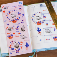 Sticker sheet with cute animal designs on a planner next to a ruler