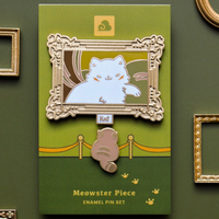 Meowster Piece enamel pin set packaging on a green background with decorative frames.