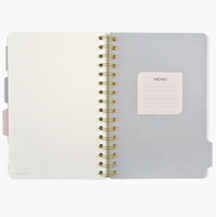 Notebook with a gold spiral binding on a white background