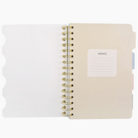 Notebook with a gold spiral binding on a white background