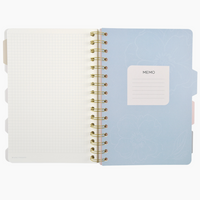 Light blue spiral-bound notebook with a white label on a white background