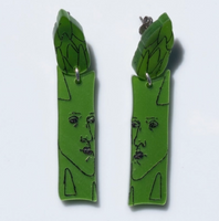 Green asparagus-shaped earrings on a white background