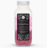 Bottle of body wash with a pink label on a white background