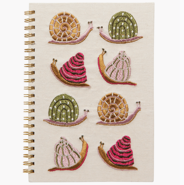 Notebook with decorative snail illustrations on a white background