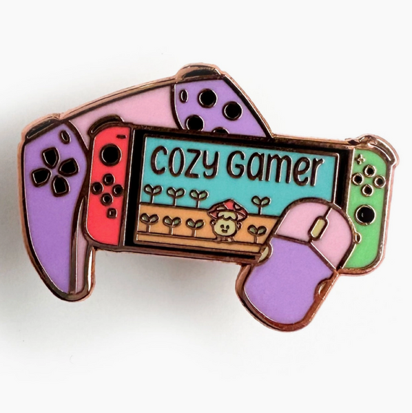 Colorful gaming console-shaped pin with 'Cozy Gamer' text on a white background