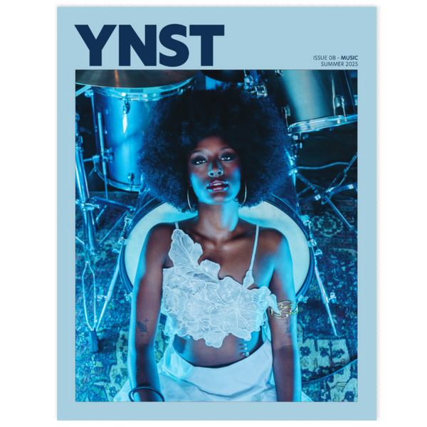 Magazine cover with a woman in a white dress and 'YNST' branding