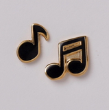 Music note earrings on a light gray background