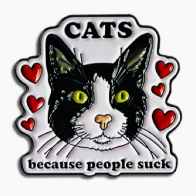 Enamel pin with a cat illustration and text on a white background