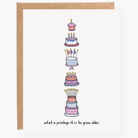 Illustration of a tiered birthday cake with candles on a white background, framed by a wooden border.