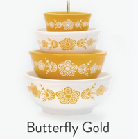 Set of four stacked bowls with gold butterfly design on a white background