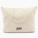 Beige tote bag with 'Stellar Factory' logo on a white background
