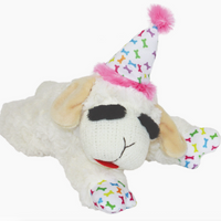 Plush toy sheep wearing a party hat with colorful bones on a white background