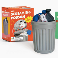 Possum toy in a trash can with packaging and guidebook on a white background