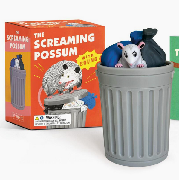 Possum toy in a trash can with packaging and guidebook on a white background