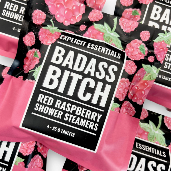 Packaging of 'Badass Bitch' red raspberry shower steamers with raspberry design on a pink background.