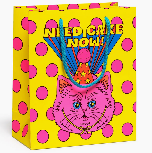 Colorful gift bag with a cat design and text on a white background
