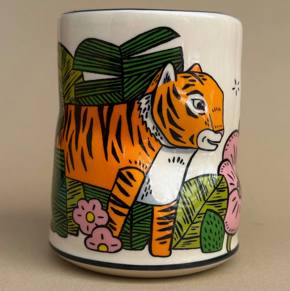 Ceramic mug with a tiger design on a beige background