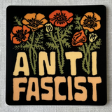 Sticker with floral design and 'A N T I FASCIST' text on a gray background