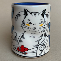 Ceramic mug with a cat design on a beige background