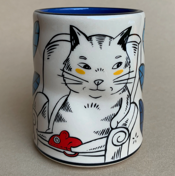 Ceramic mug with a cat design on a beige background