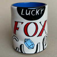 Mug with 'Lucky Fox' design on a plain background
