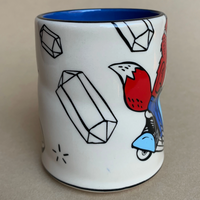 White mug with colorful designs on a beige background