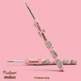 Pink crochet hook with 'Pusheen' branding on a pink background