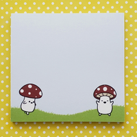 Notepad with cartoon characters under mushrooms on a yellow polka dot background