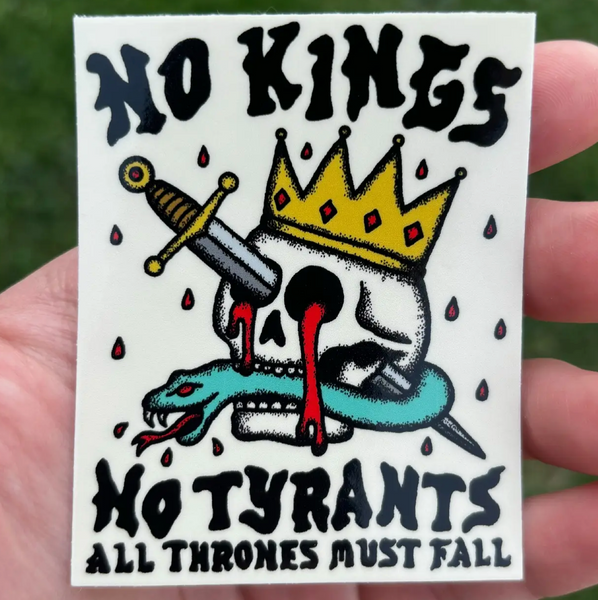 Sticker with 'No Kings, No Tyrants' design held in a hand against a grassy background